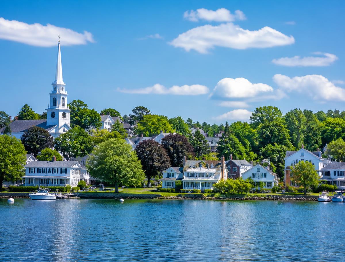 Connecticut lakeside town with white colonial homes and a church steeple